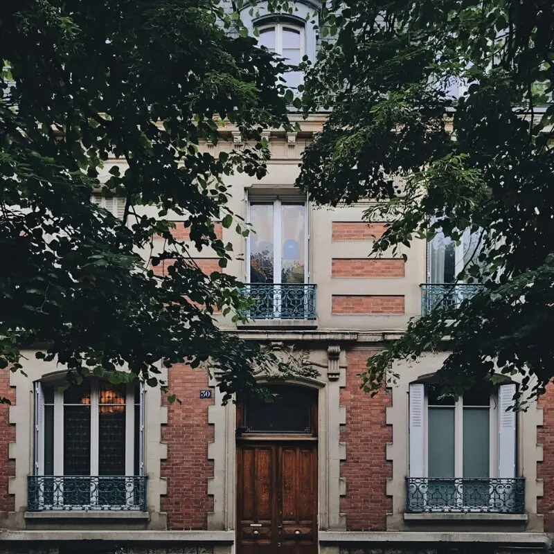 Residential facade framed by leafy branches
