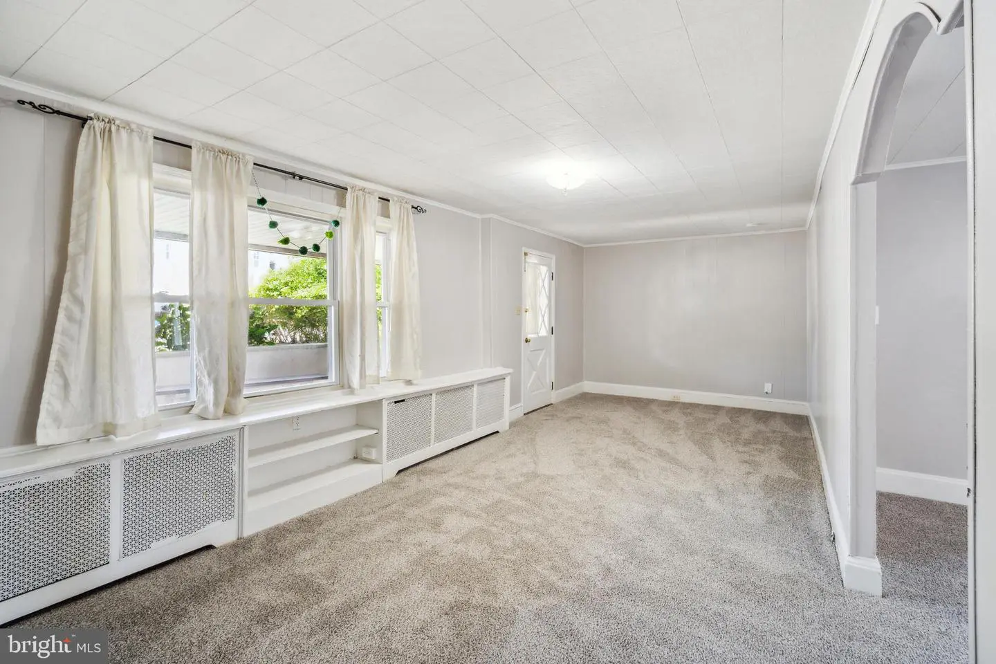 Bright empty living room with large windows