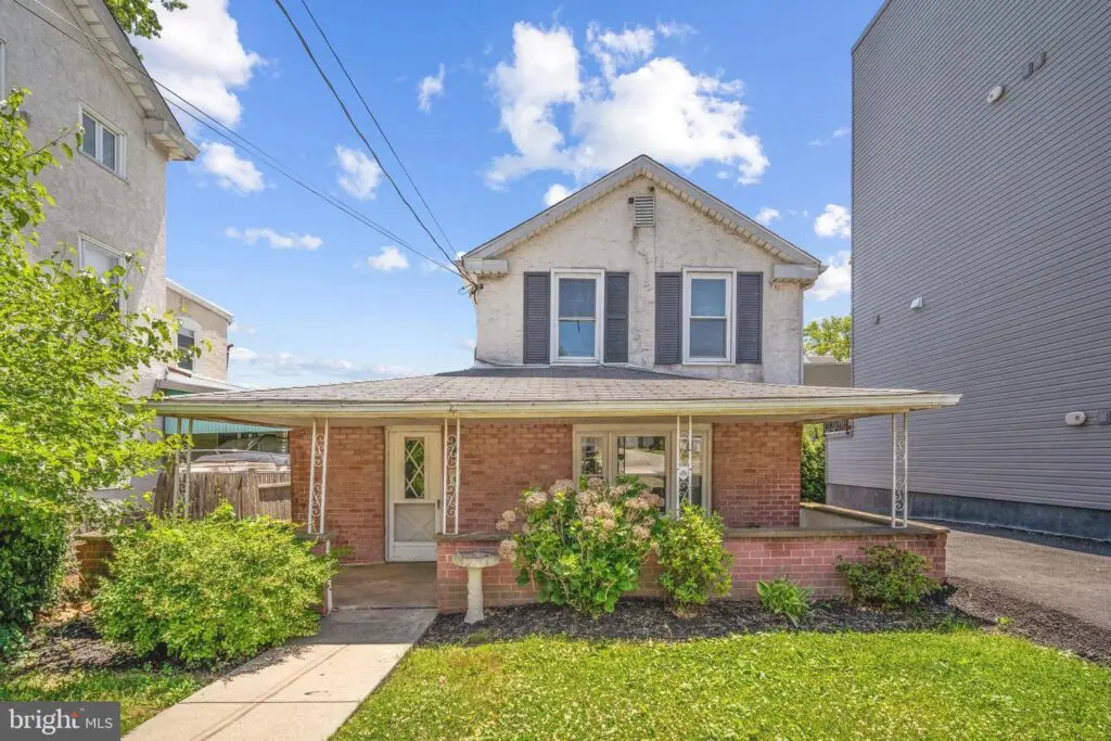 Two story brick house with covered front porch