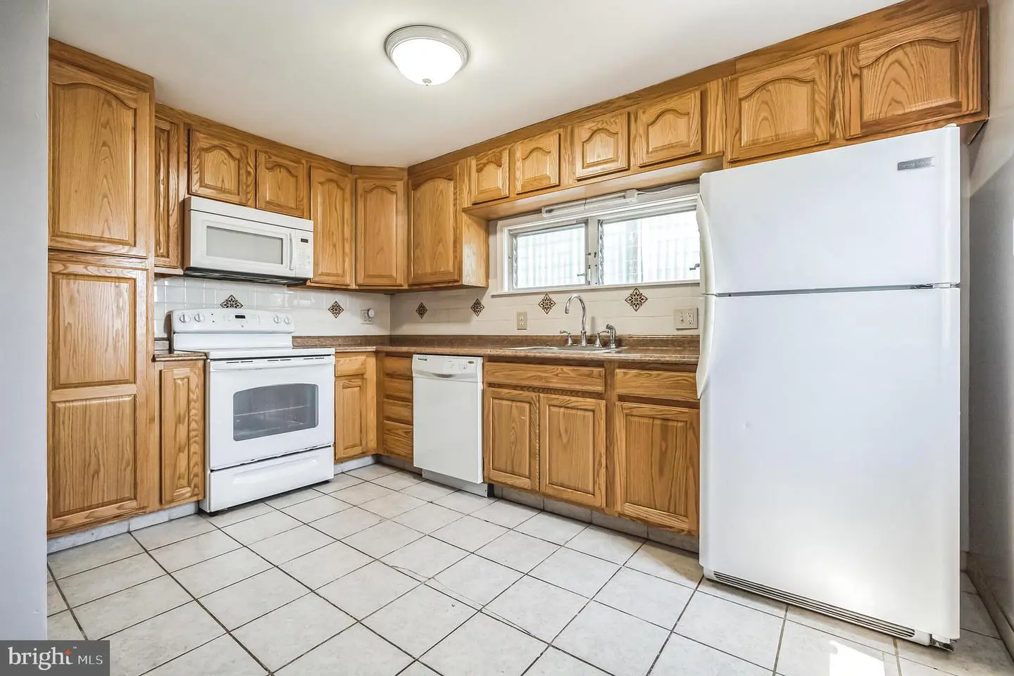 Kitchen with oak cabinets and white appliances