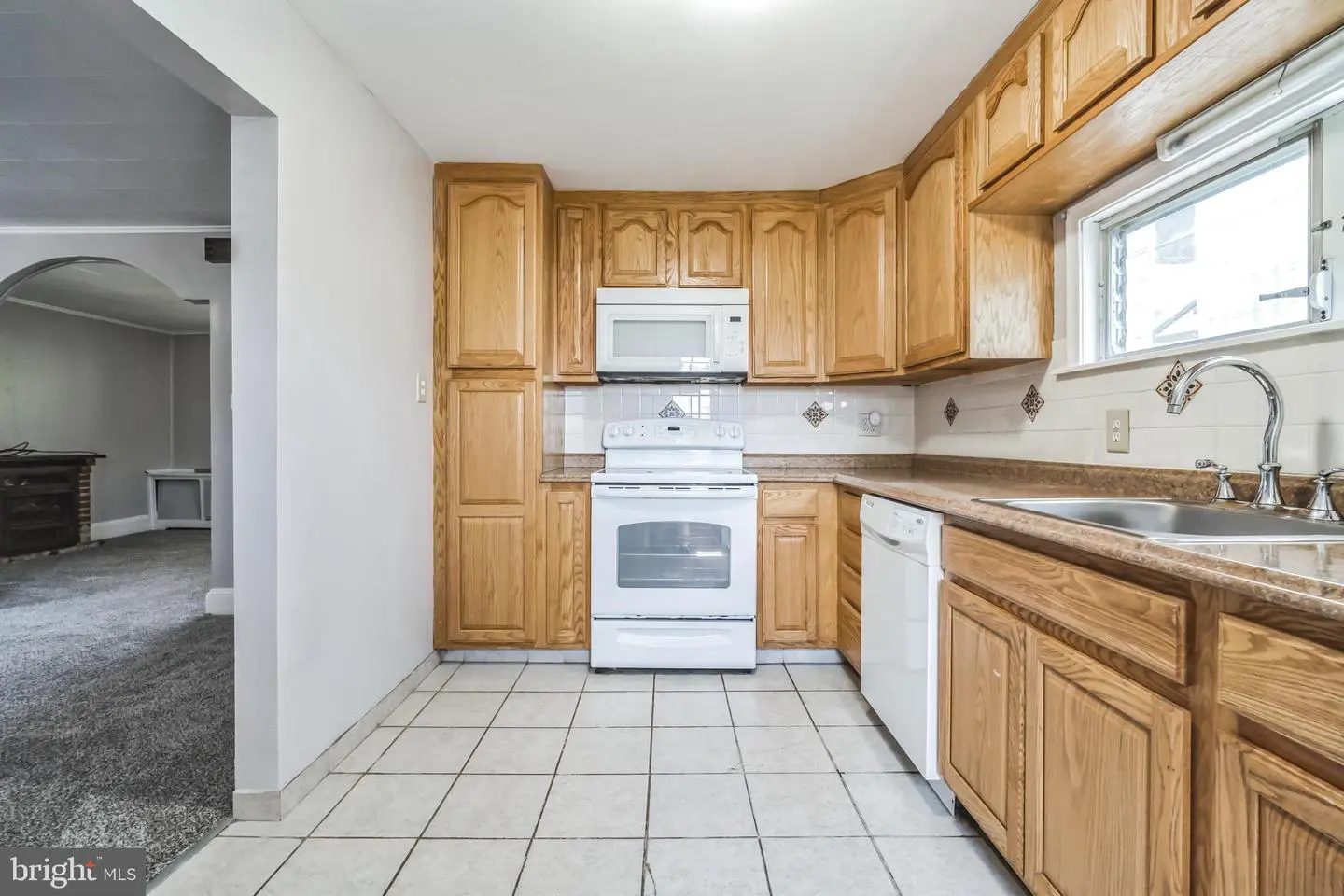 Kitchen with oak cabinets and white appliances
