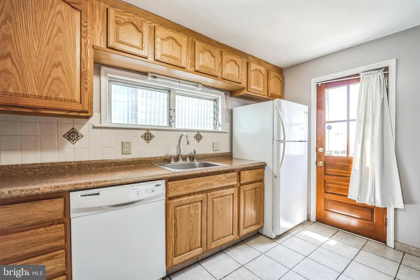 Kitchen with oak cabinets and white refrigerator