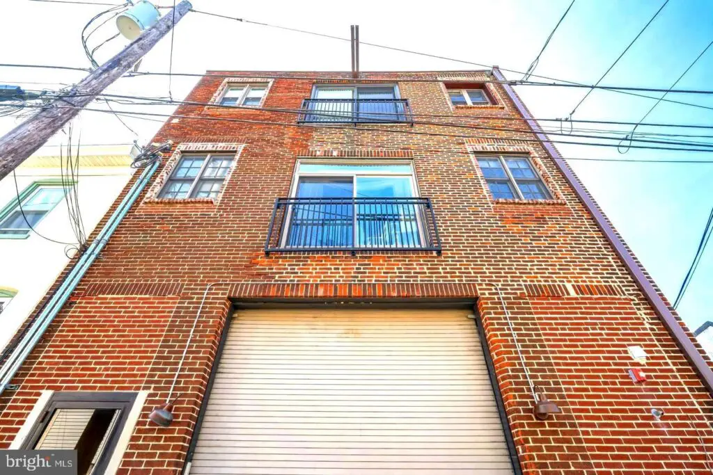 Urban red brick building facade with garage door