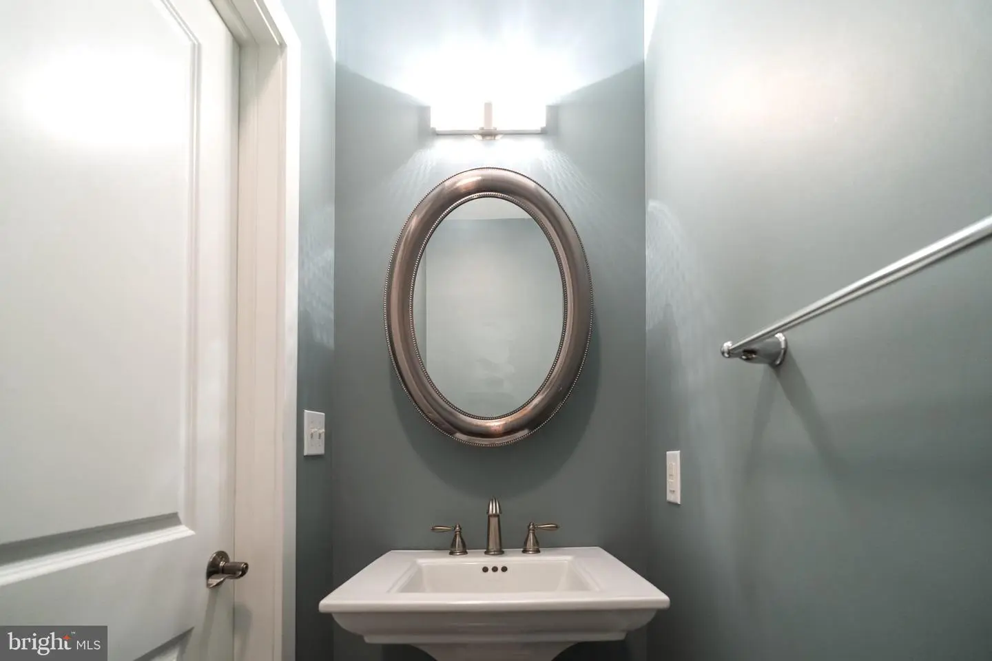 Small bathroom with pedestal sink and mirror