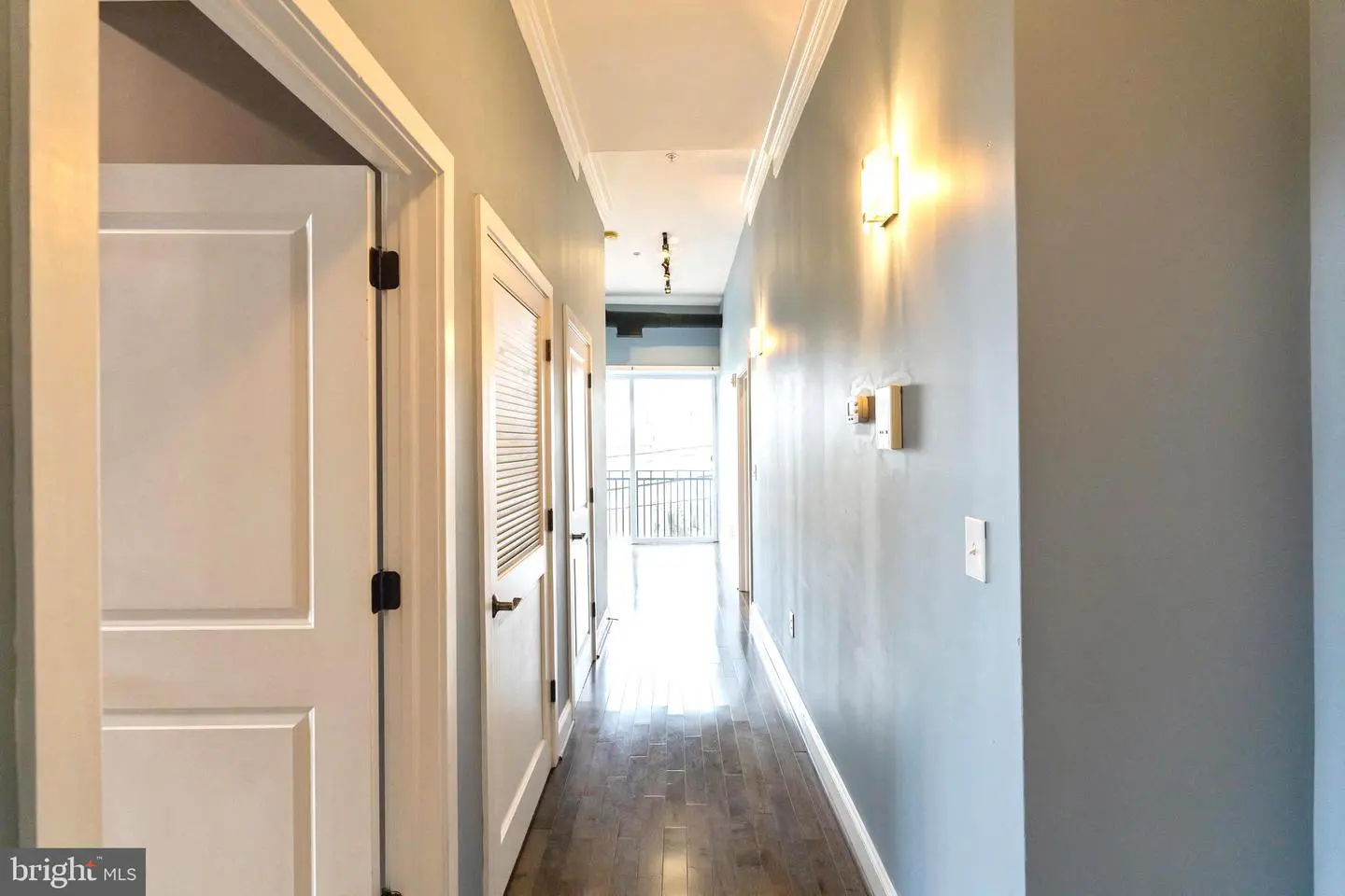 Modern apartment hallway with hardwood floors