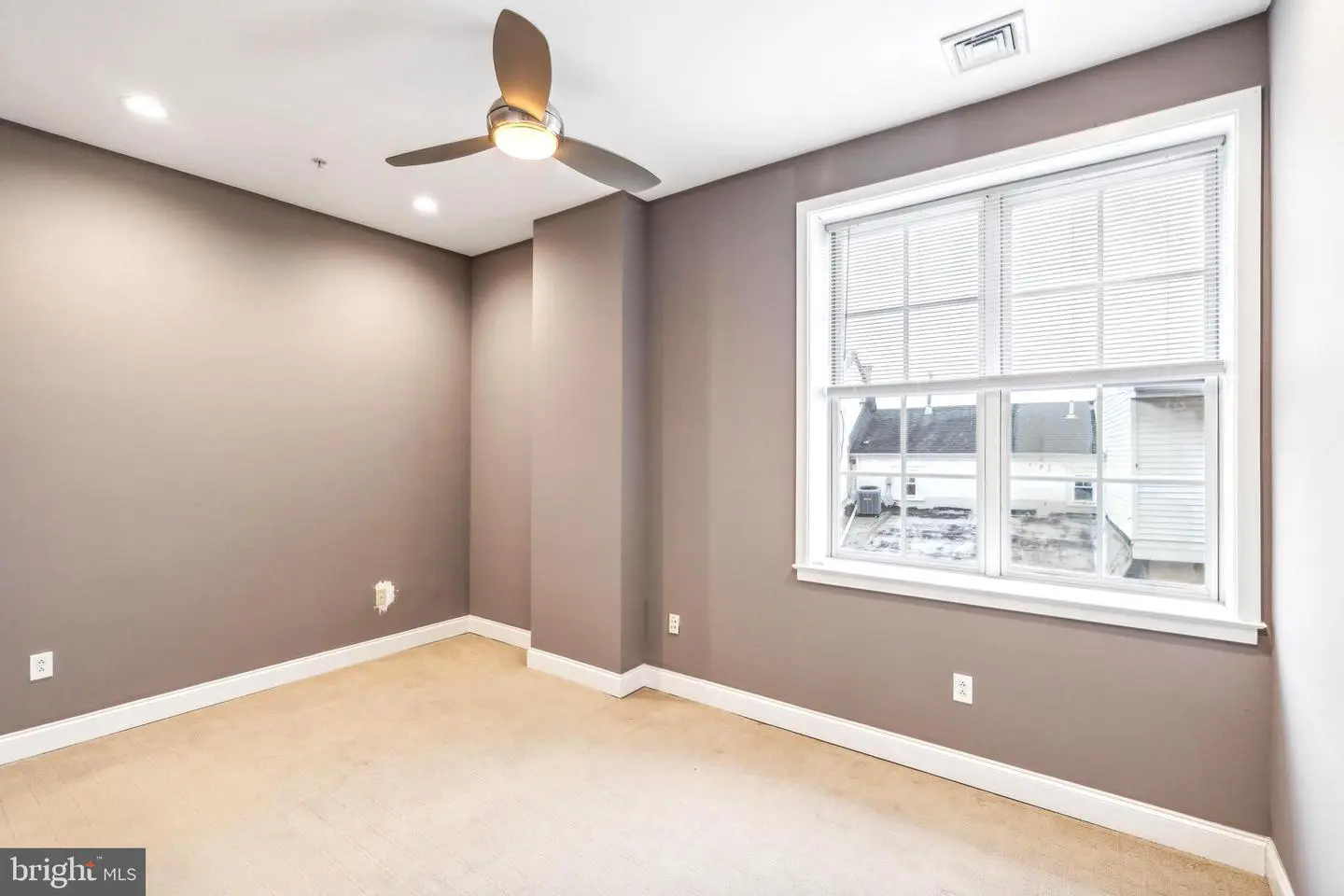 Empty bedroom with ceiling fan and window
