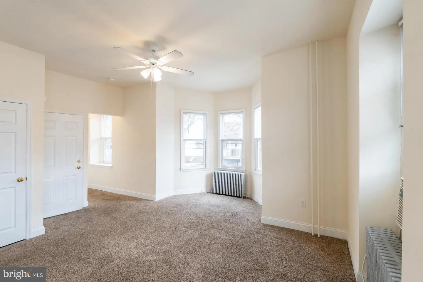 Bright empty living room with bay windows