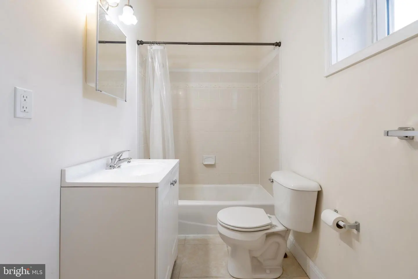 Small white bathroom with bathtub and toilet