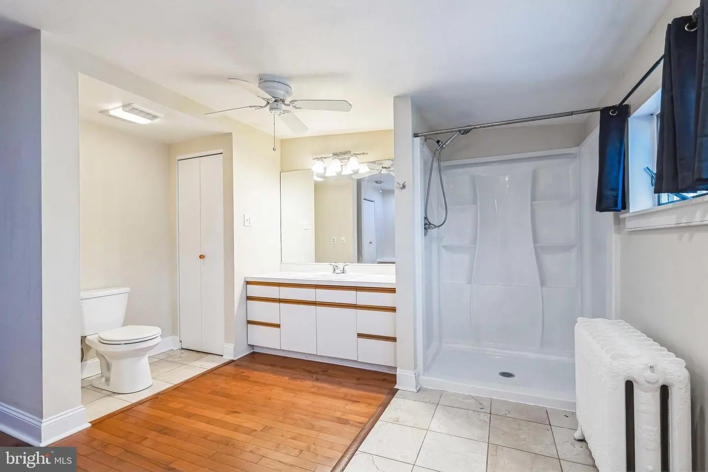 Bright bathroom with walk-in shower and vanity