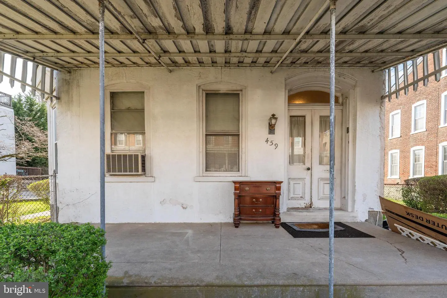 Covered front porch with dresser and white door