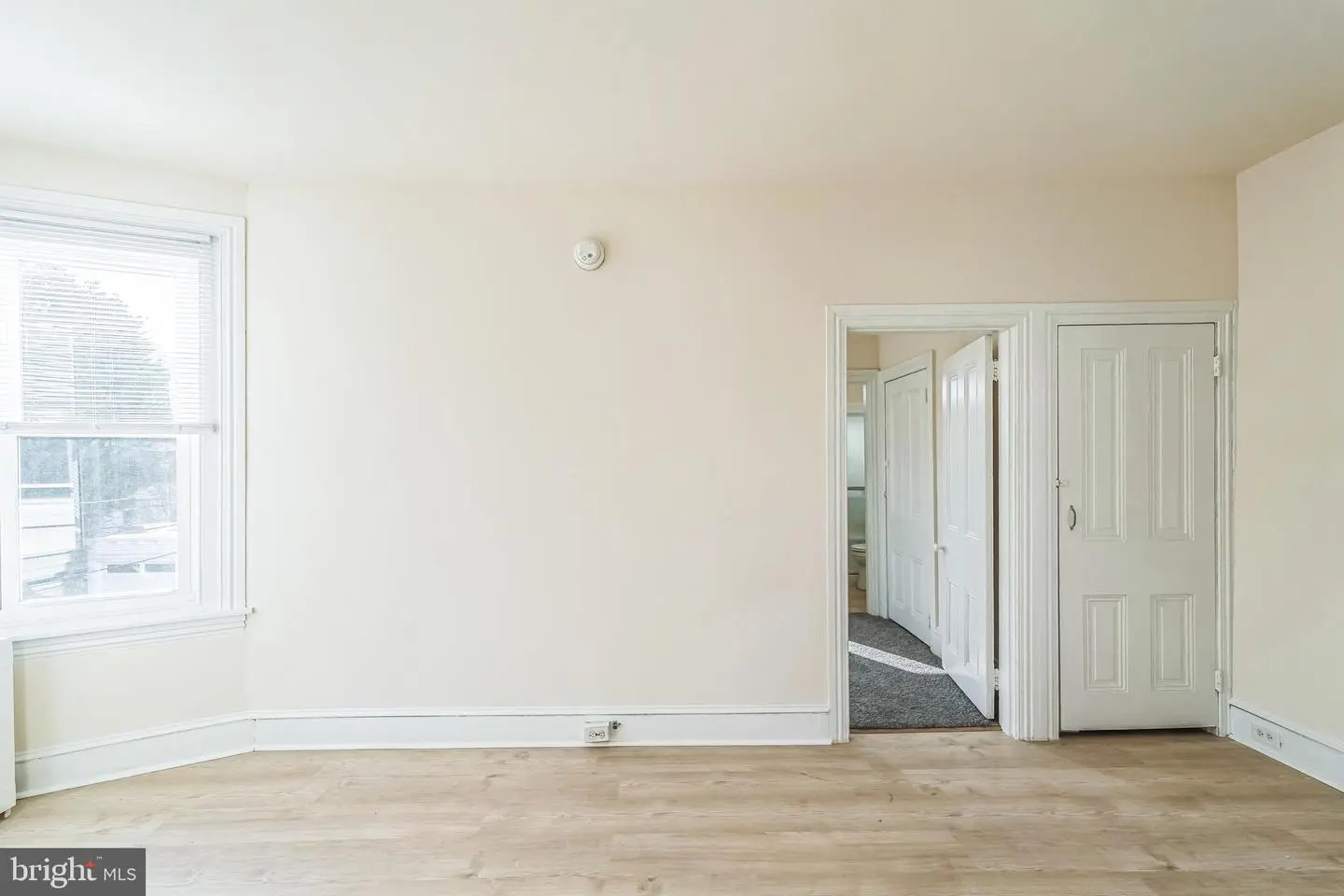Empty bright room with window and doorway