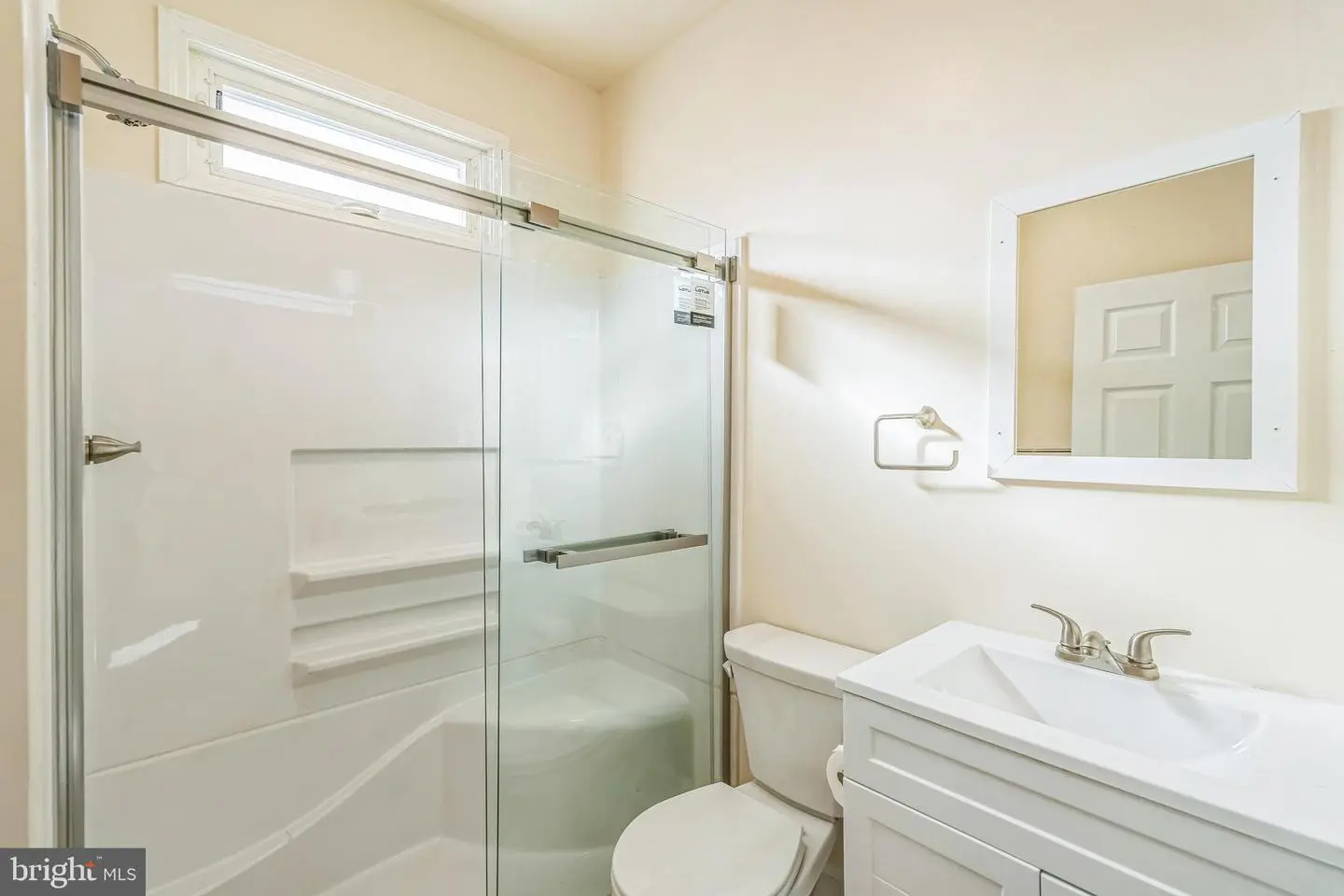 Small modern bathroom with glass shower and vanity