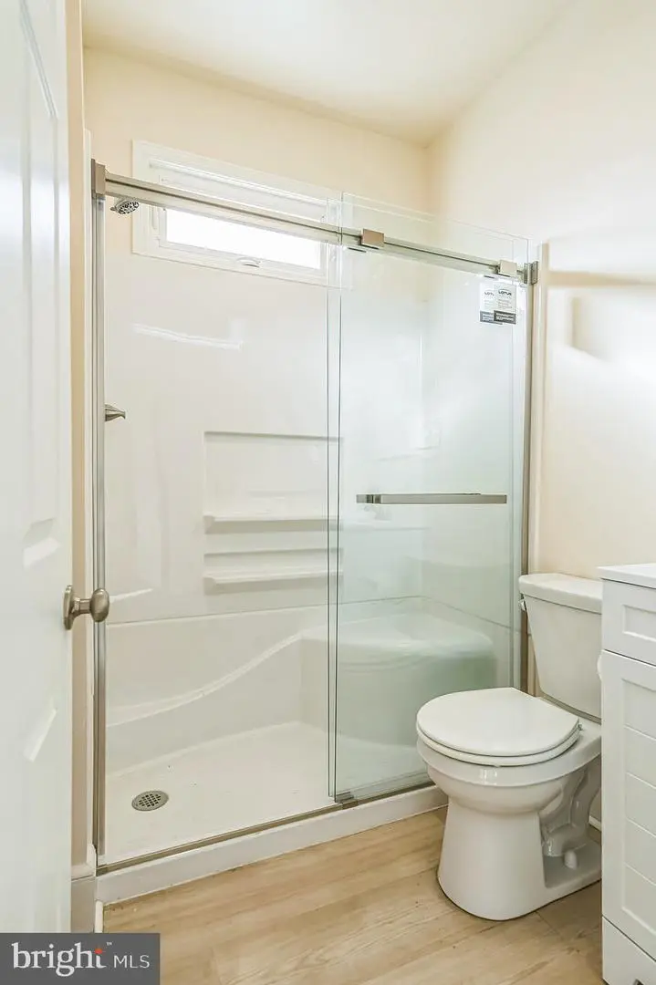 Small bathroom with glass shower and toilet