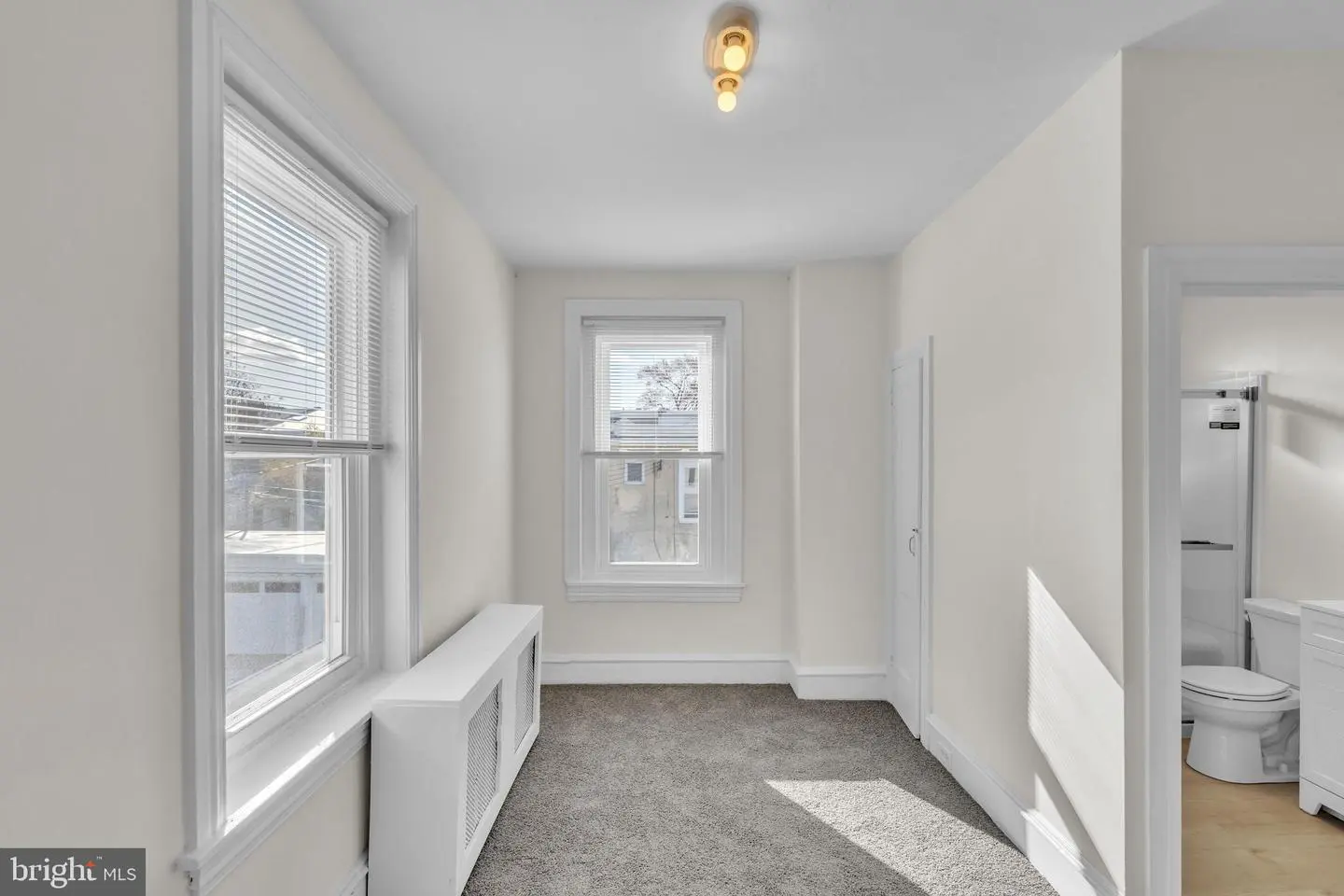Small bright bedroom with two windows
