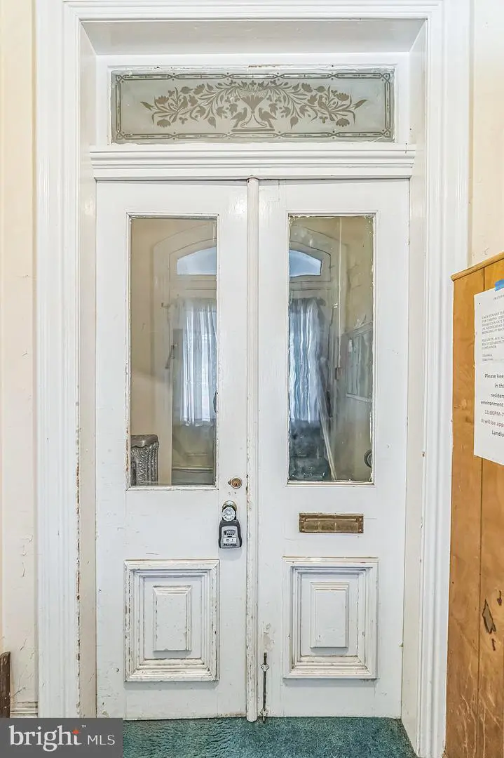Antique white double door with glass panels