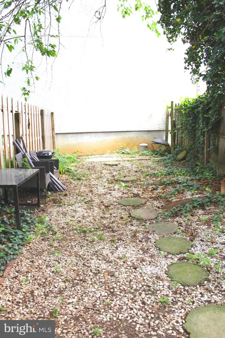 Small gravel backyard with stepping stones
