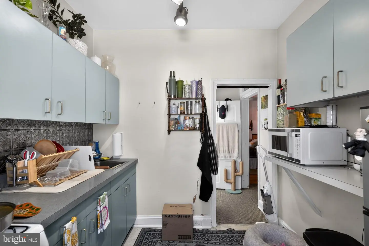Compact kitchenette with microwave and cabinets