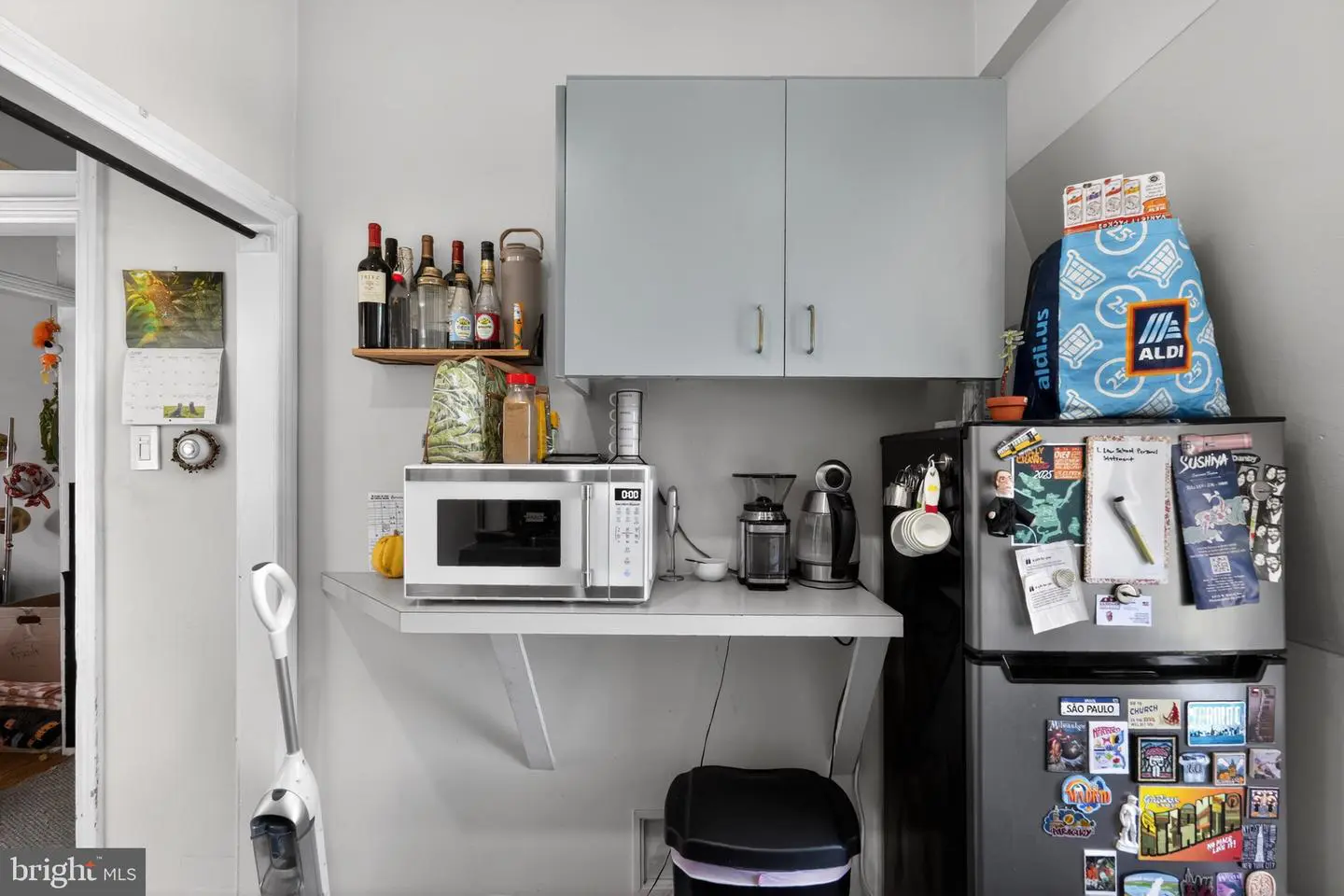 Compact kitchenette with microwave, coffee maker, refrigerator