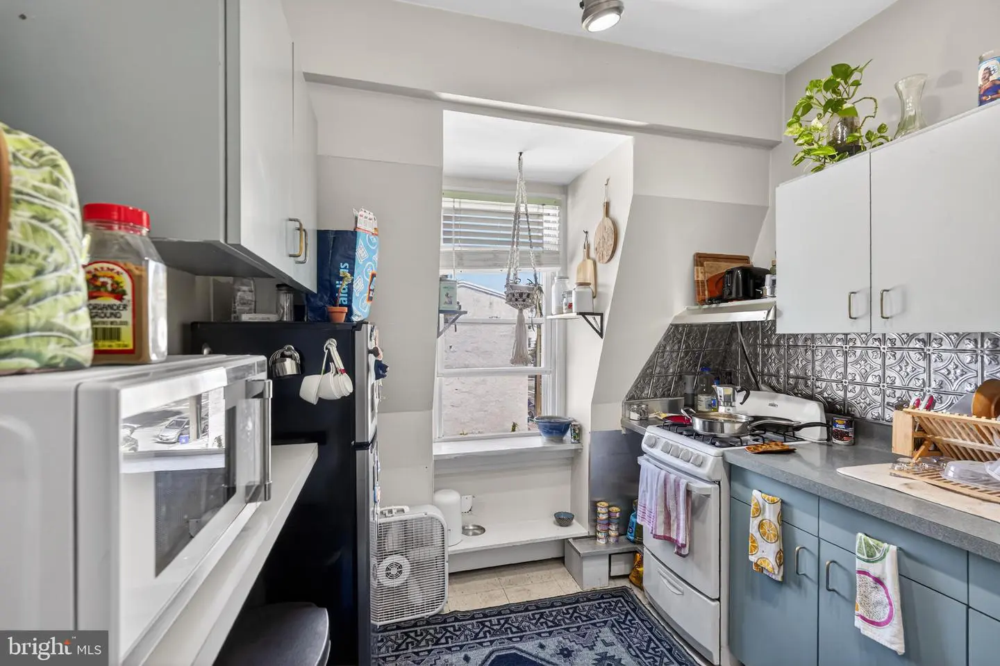 Small bright apartment kitchen with stove