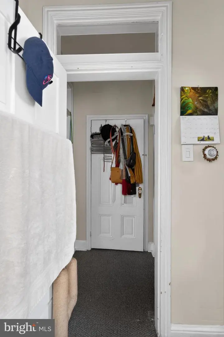 Hallway with closed door and hanging coats