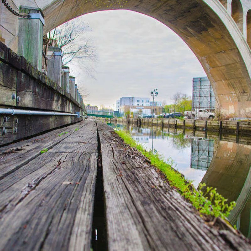 Wooden path under stone bridge