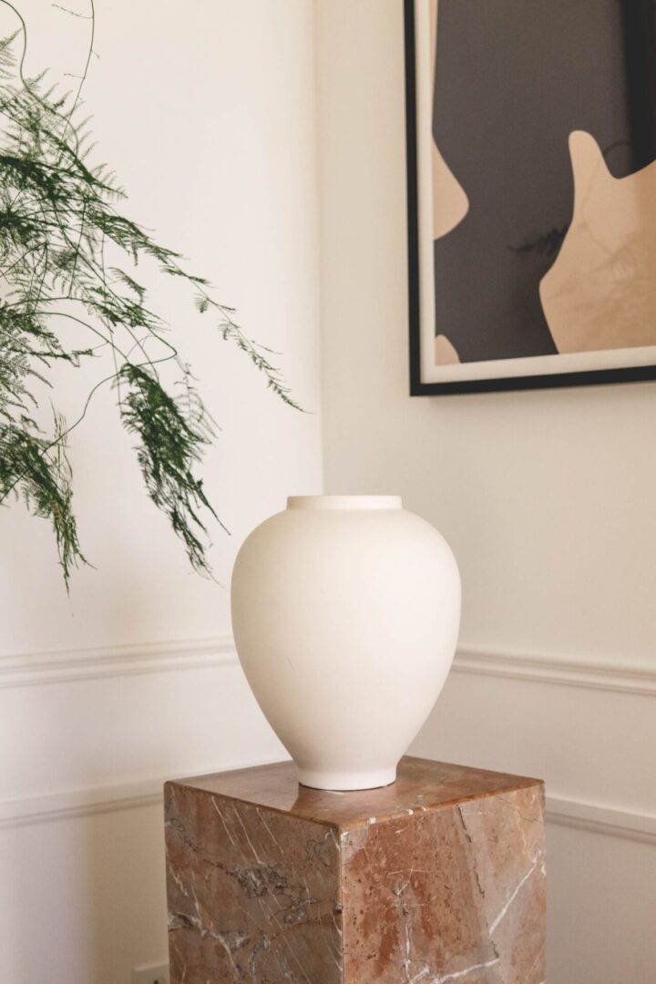 White vase on marble pedestal